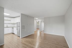 Denver apartment for rent - A kitchen with white appliances and wooden floors.