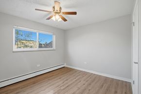Denver apartment for rent - A room with a ceiling fan and a window.