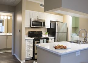 Broomfield apartment for rent - a kitchen with white cabinets and stainless steel appliances