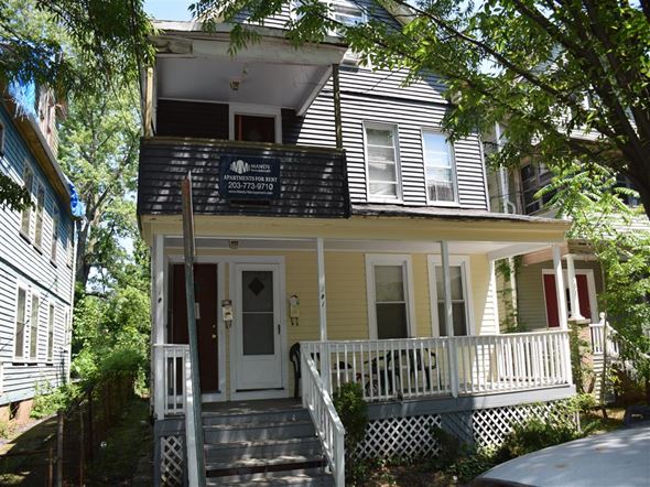New Haven apartment for rent - A house with a porch and a sign on the front.