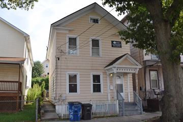 New Haven apartment for rent - A two-story house with a front porch and a sign on the front.