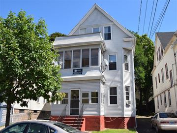 New Haven apartment for rent - A white two-story house with a red staircase.