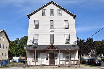 New Haven apartment for rent - A two-story white house with a brown door and windows.