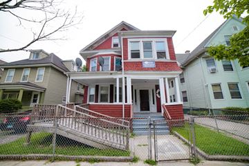 New Haven apartment for rent - A red and white two story house with a porch and a fence.