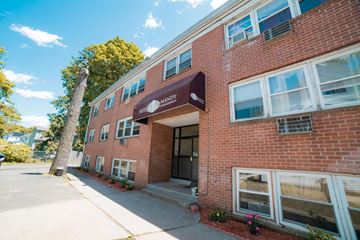 New Haven apartment for rent - The image shows a red brick building with a brown awning and white windows.