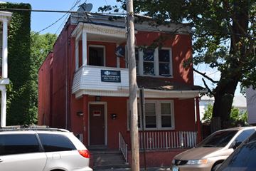 New Haven apartment for rent - A red building with a white sign on the front.