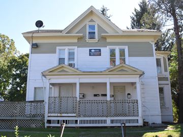 New Haven apartment for rent - A white house with a yellow roof and a balcony.