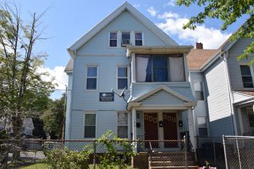 New Haven apartment for rent - A white house with a red door and a sign on the front.