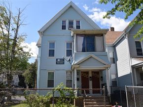 New Haven apartment for rent - A blue house with a red door and a sign on the front.
