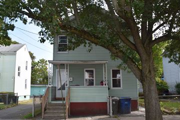 New Haven apartment for rent - A green house with a tree in front.