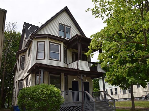 New Haven apartment for rent - A house with a brown roof and white walls with a balcony.