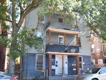 New Haven apartment for rent - A two-story house with a blue exterior and a white door.