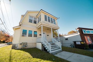 New Haven apartment for rent - A two-story house with a white front porch.