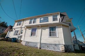 New Haven apartment for rent - A two-story house with a sign that says "Mandi" on the front.