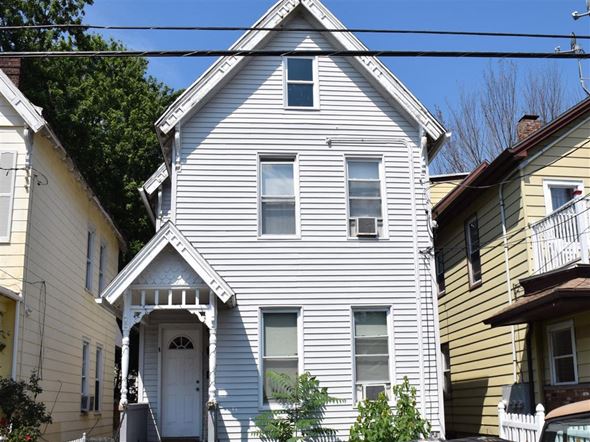 New Haven apartment for rent - A white house with a grey roof and a brown door.