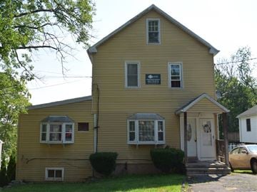 New Haven apartment for rent - A yellow house with a white door and windows.