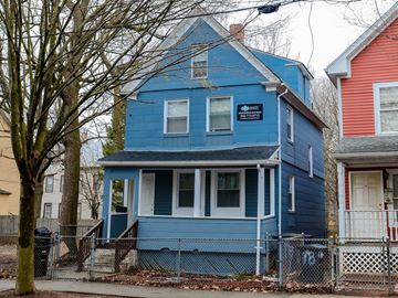 New Haven apartment for rent - A blue house with a white door and a sign on the front.
