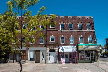 New Haven apartment for rent - A red brick building with a white awning and a sign that says "ATM".