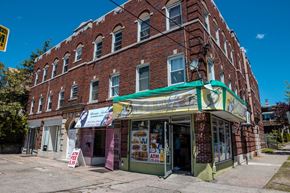 New Haven apartment for rent - A red brick building with a green awning and a sign that says "ATM".