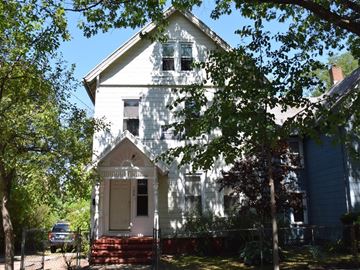New Haven apartment for rent - A white house with a brown door and a small porch.