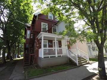 New Haven apartment for rent - A house with a red brick exterior and a white porch.