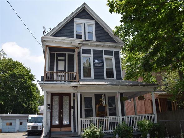 New Haven apartment for rent - A two-story house with a balcony and a porch.