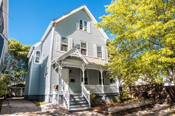 New Haven apartment for rent - A two-story house with a front porch and a tree in front.