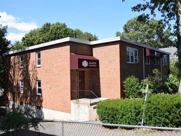 New Haven apartment for rent - A red brick building with a sign that says MANDI in front of it.