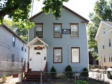 New Haven apartment for rent - A blue house with a white door and a sign on the front.