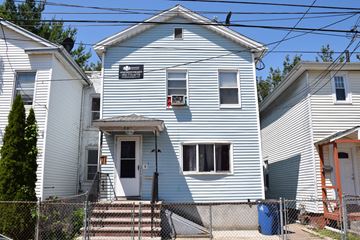 New Haven apartment for rent - A white house with a black sign on the front.