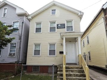New Haven apartment for rent - A two-story house with a white door and a small porch.