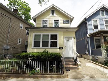 New Haven apartment for rent - A yellow house with a white door and a small porch.