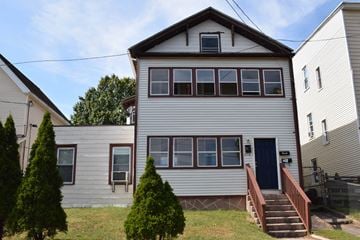 New Haven apartment for rent - A two-story house with a blue door and a staircase leading to the entrance.