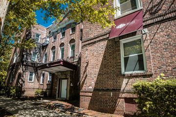 New Haven apartment for rent - A building with a red awning and a tree in front.