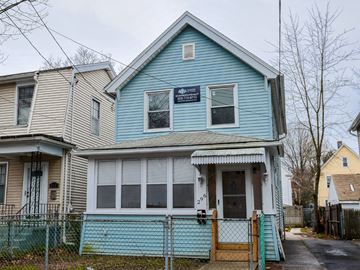 New Haven apartment for rent - A blue house with a sign on the front window.