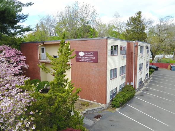 New Haven apartment for rent - A parking lot in front of a building with a sign that says "Manday".