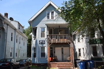 New Haven apartment for rent - A blue house with a porch and a sign on the front.