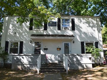 New Haven apartment for rent - A white house with black shutters and a porch.