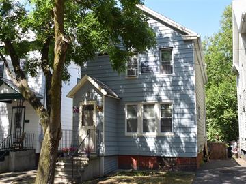 New Haven apartment for rent - A small blue house with a tree in front.
