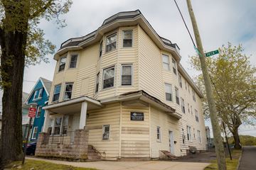 New Haven apartment for rent - A two-story building with a balcony on the second floor.