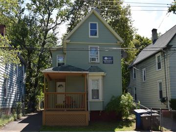 New Haven apartment for rent - A house with a porch and a sign on the front.