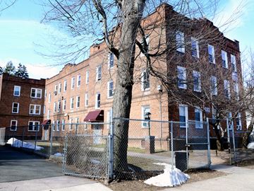 New Haven apartment for rent - A large brick building with a fence in front of it.