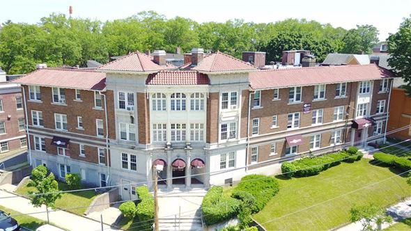 New Haven apartment for rent - A large red brick building with a green lawn in front.