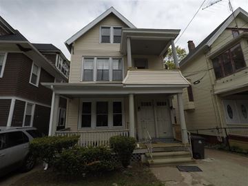 New Haven apartment for rent - A house with a white door and a small porch.