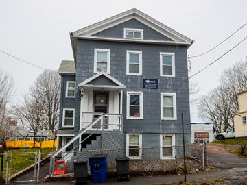 New Haven apartment for rent - A grey two story house with a sign on the front.