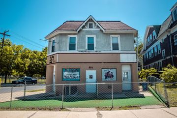 New Haven apartment for rent - A small building with a sign that reads "INFANTILES" sits in front of a fence.