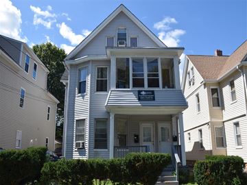New Haven apartment for rent - A two-story house with a porch and a balcony.