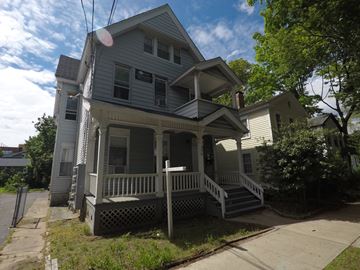 New Haven apartment for rent - A two-story house with a porch and a front yard.