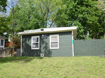 New Haven apartment for rent - A small green house with a white window and a white door.