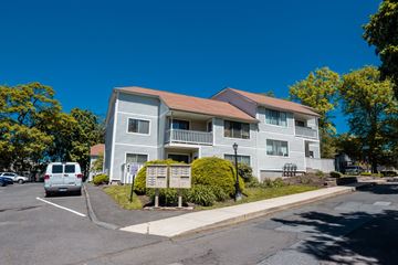 New Haven apartment for rent - A large building with a brown roof and a white van parked in front.